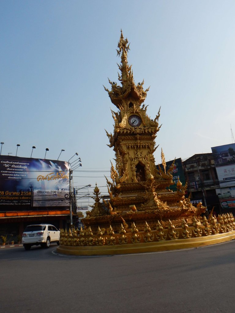 The golden clock tower was designed by Chalermchai Kositpipat, the artist who created the White Temple. 