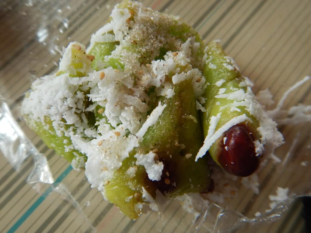 Mae Salong in Northern Thailand pandan and red bean covered in coconut shavings and sugar with sesame seeds. 