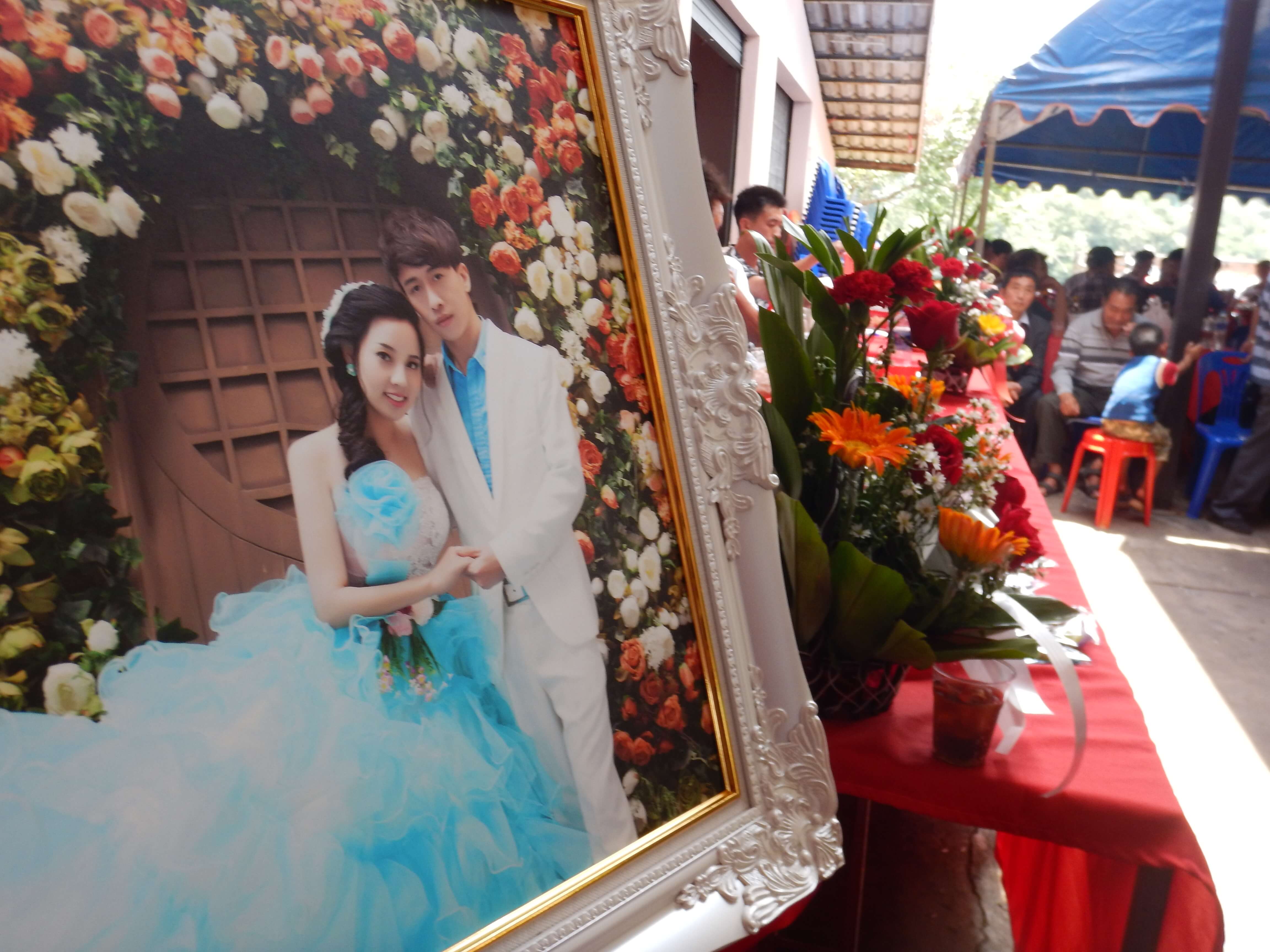 Mae Salong in Northern Thailand the portrait of a couple who is getting married with flowers and wedding guests in the background