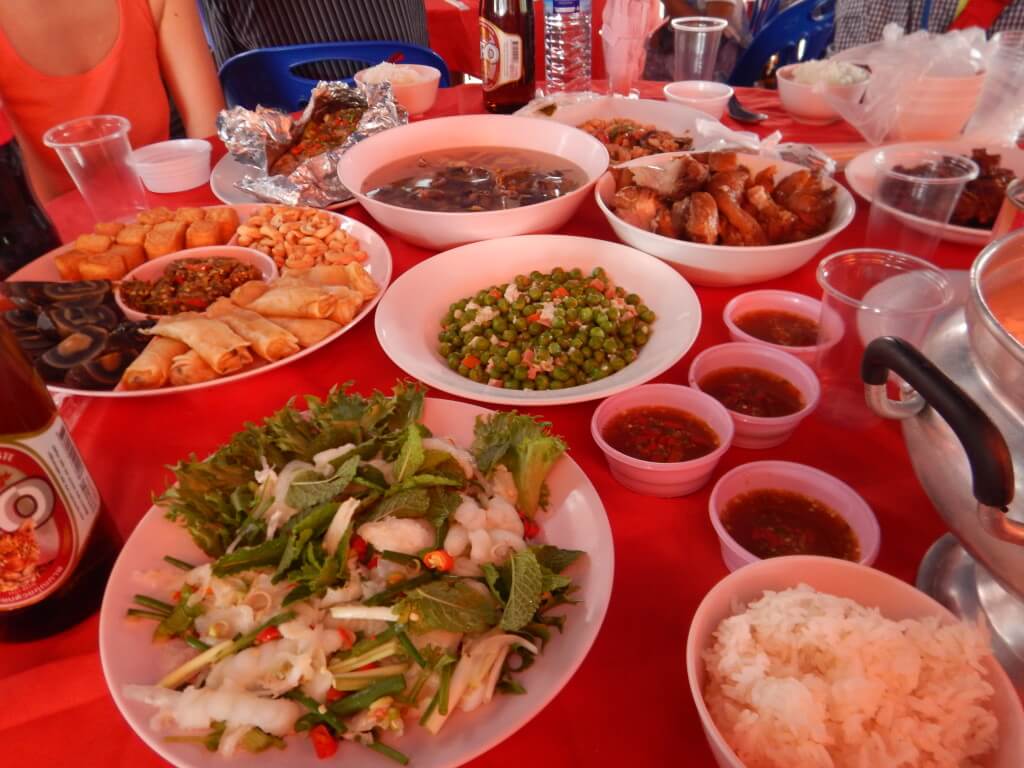 Mae Salong in Northern Thailand a table with a red table cloth covered in Chinese and Thai dishes 