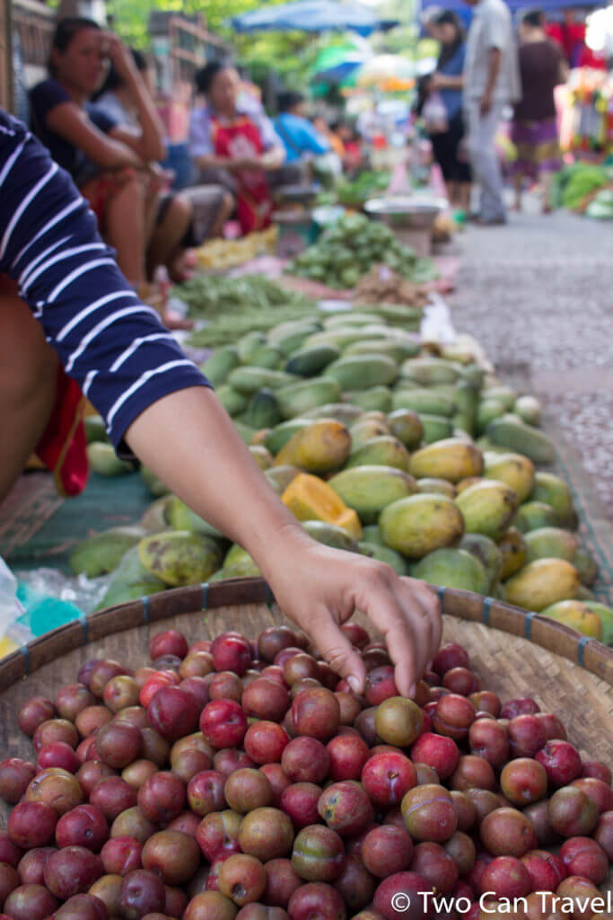 Shopping for fruit at the local market, one of the most interesting things to do in Luang Prabang