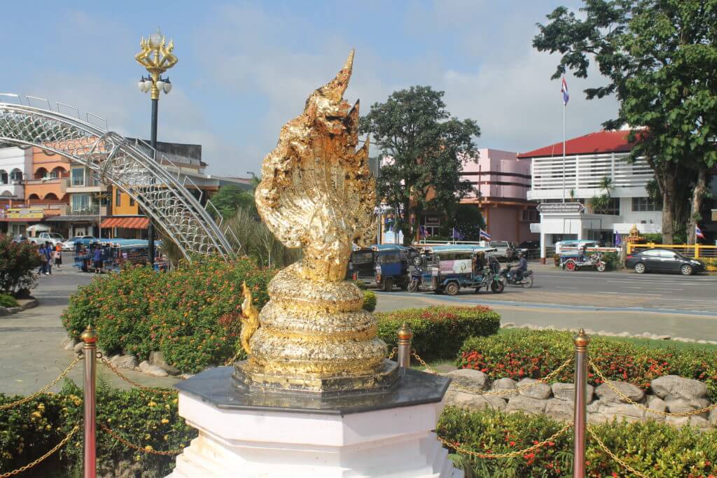 The mini golden Naga statue in Nakhon Phanom, Thailand by Two Can Travel